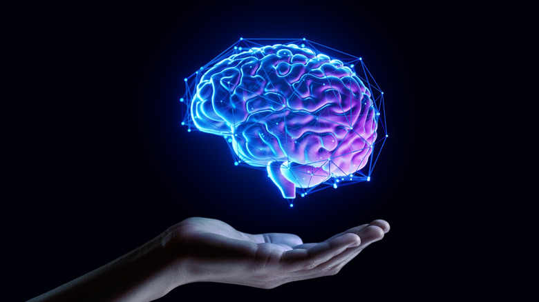 An outstretched hand with a 3D graphic of a brain floating above it