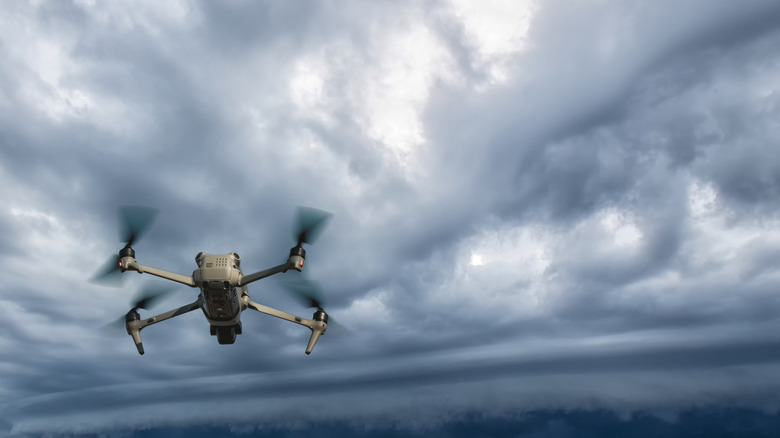 Quadcopter drone flies near rain clouds
