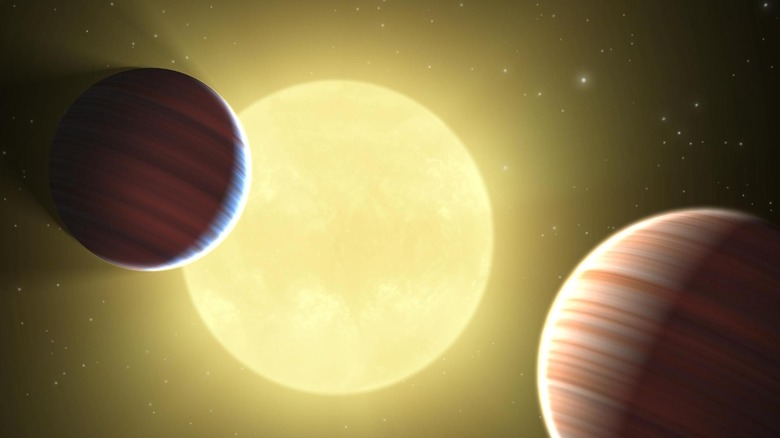 Illustration of two Saturn-sized planets discovered by NASA Kepler mission passing in front of star Kepler-9.