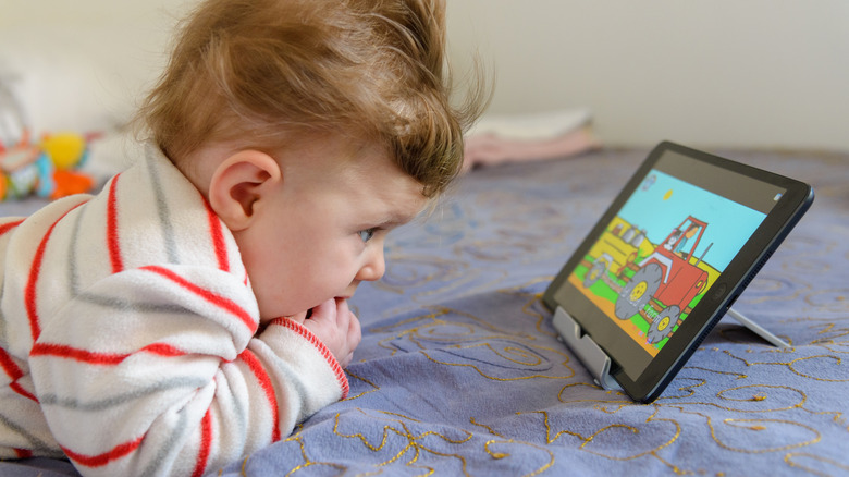A toddler looking at an iPad.