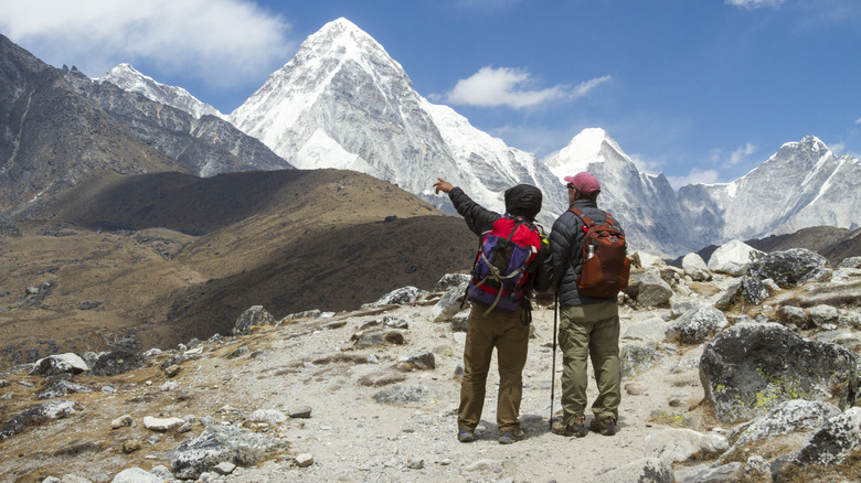Sherpa guiding climber on Everest Base Camp trail