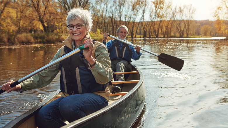 Happy couple canoeing together on a lake
