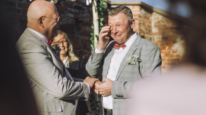 Gay couple getting emotional during wedding ceremony