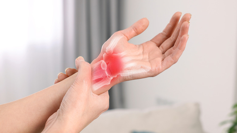 Person experiencing inflammation in hand and wrist joints