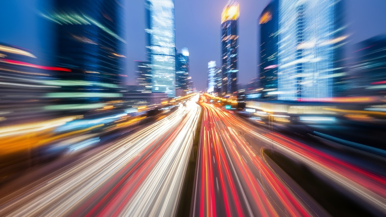 Blurred city roads representing high speed travel