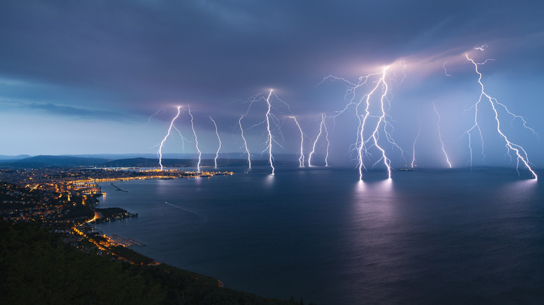 Multiple bolts of lightning striking the ocean