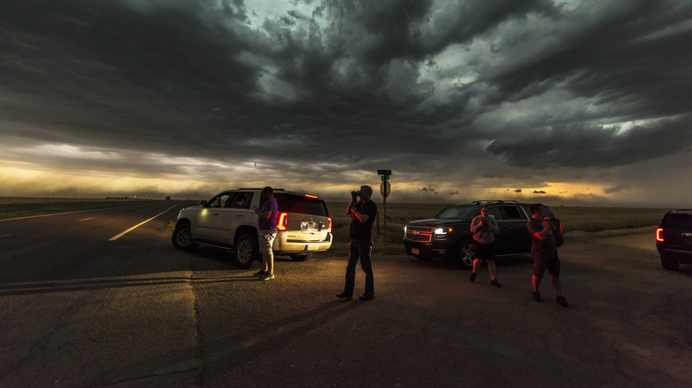 Vehicles pulled over on side of road waiting for tornado