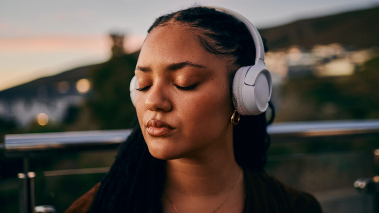 A woman with headphones on.
