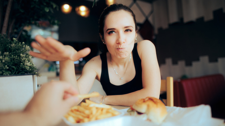 A woman on a date is having a problem with food