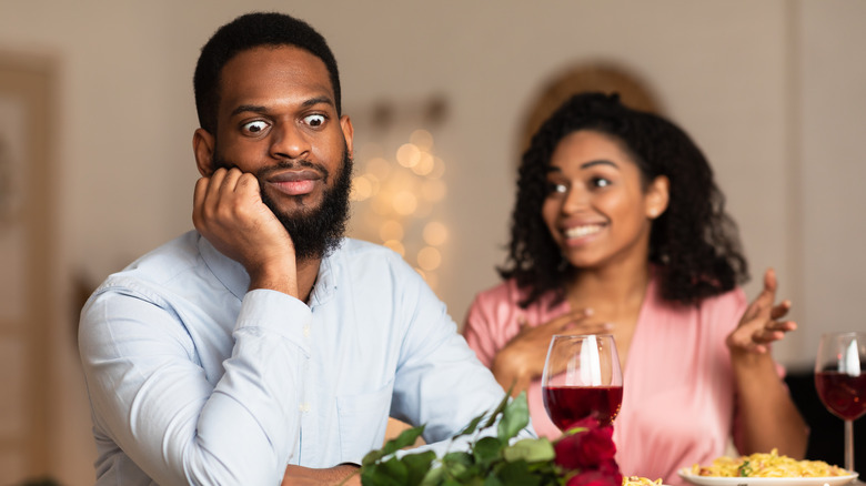Shocked man is on a date with a talkative woman