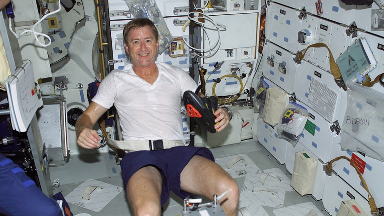 Astronaut Frank Culbertson is exercising on a bicycle ergometer on the space shuttle Discovery