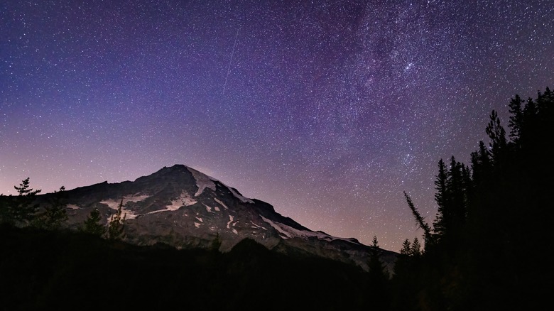 Beautiful landscape view of the Milky Way rising over Mount Rainier in Mount Rainier National Park.