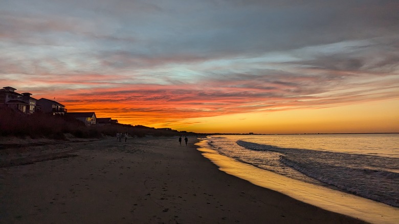 The sun is setting on a beach in Chesapeake Bay