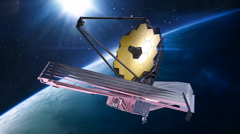 Concept of the James Webb Space Telescope above Earth as it orbits the sun