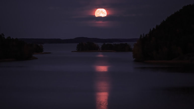Red moon over water