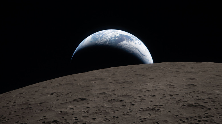 The moon's surface with earth visible in the background