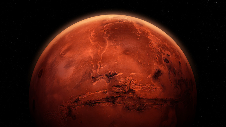 Mars is seen against the black background of space