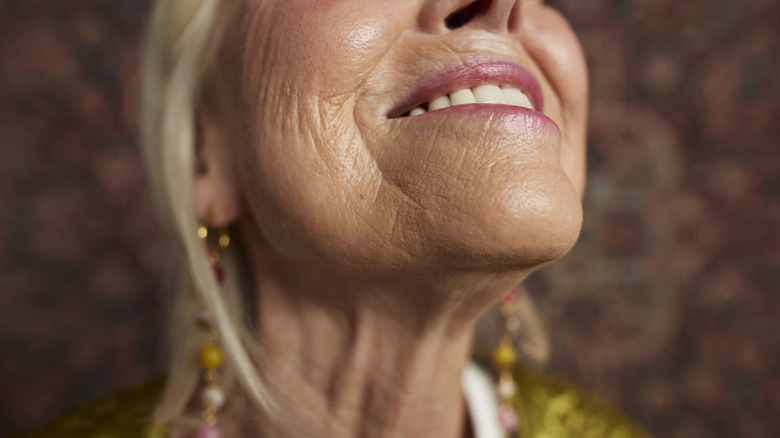 A woman is seen in closeup smiling
