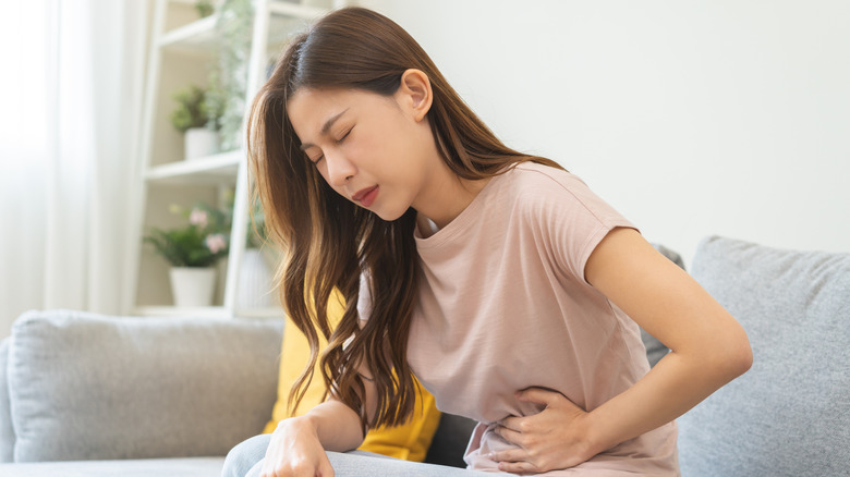Young woman suffering from digestive pain