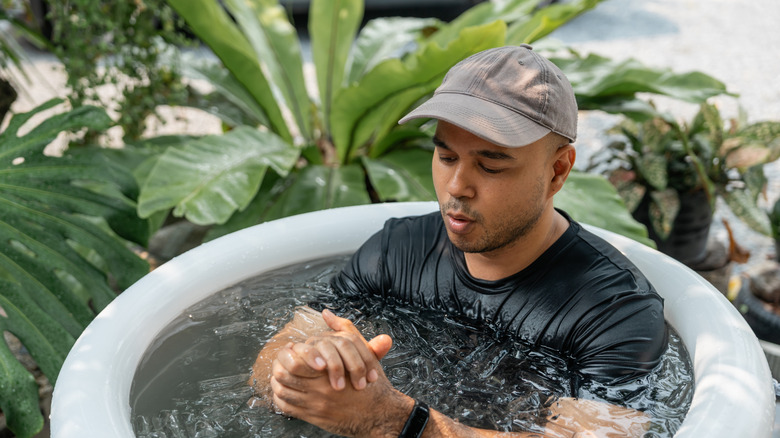 A man sitting in an ice bath