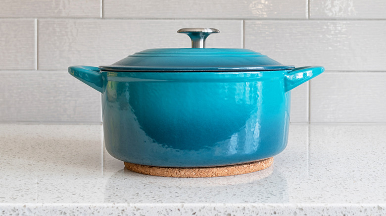 Turquoise casserole pot sitting on counter top