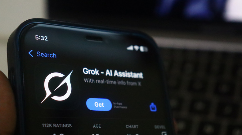 A mobile phone with Grok download button on the screen