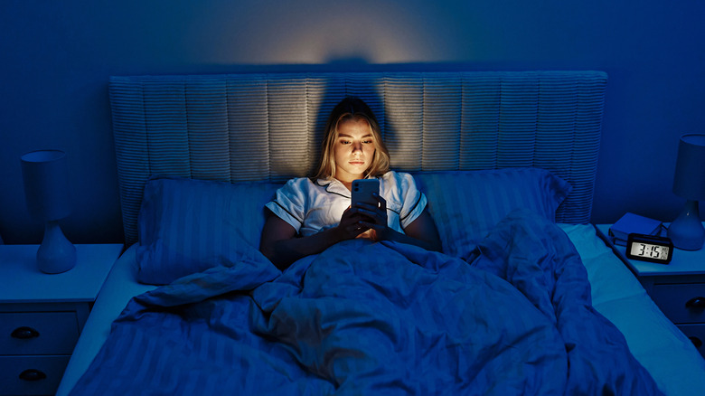 Woman awake in middle of the night using her smartphone