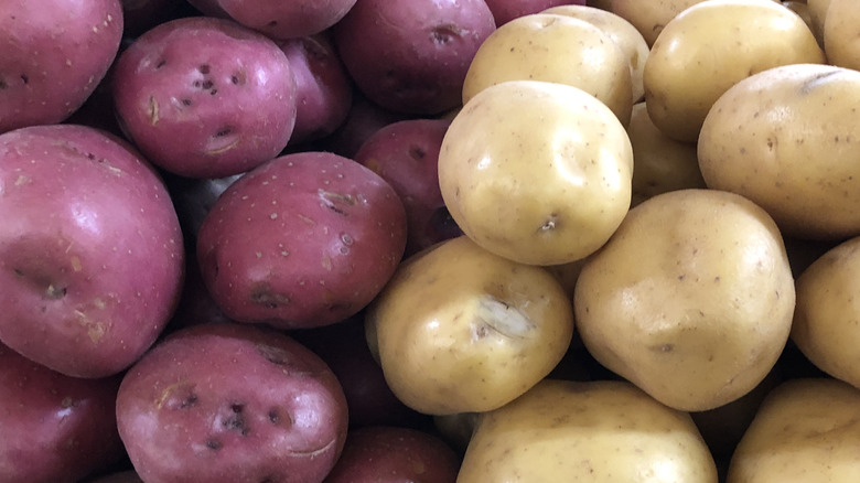 Red (left) and white (right) potatoes stacked next to each other