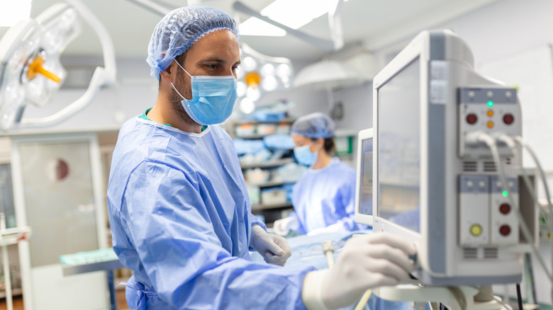 Physician monitoring a ventilator in a hospital