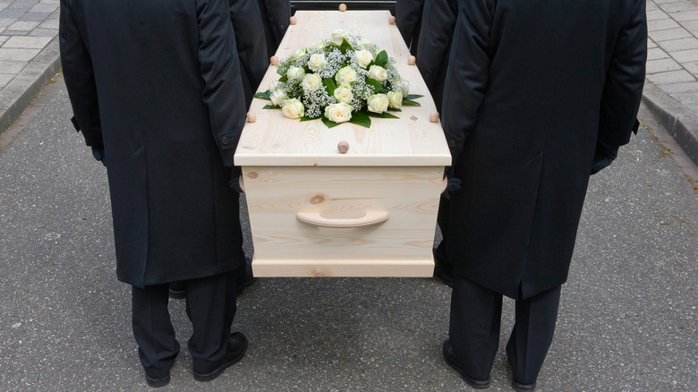 pallbearers carrying coffin