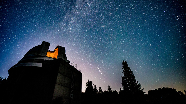 Milky Way crossing the night sky above the dome of an observatory
