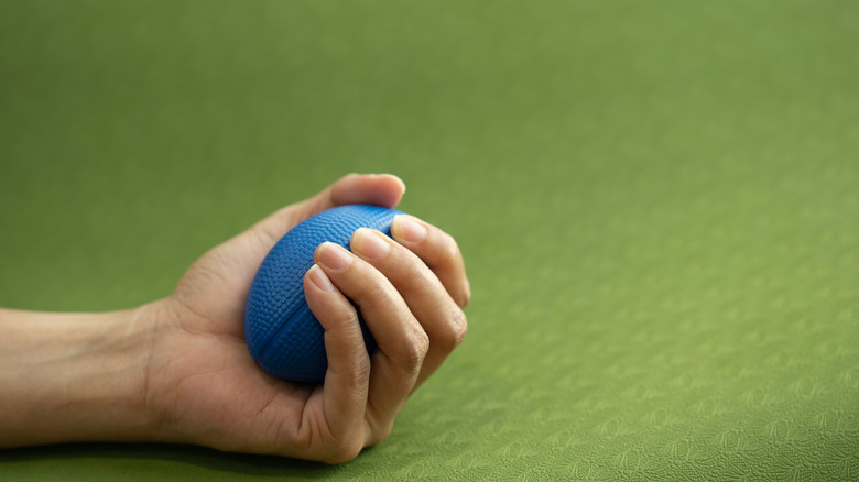 Blue stress ball in the hand of a woman
