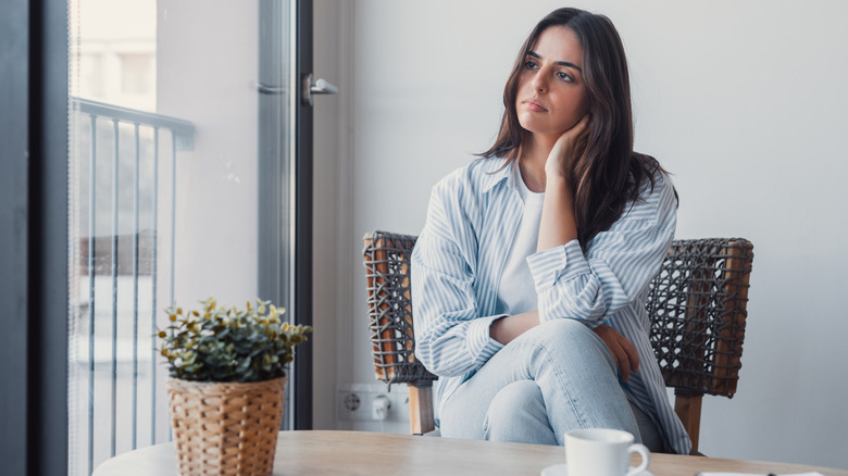 Woman in chair with apathetic expression