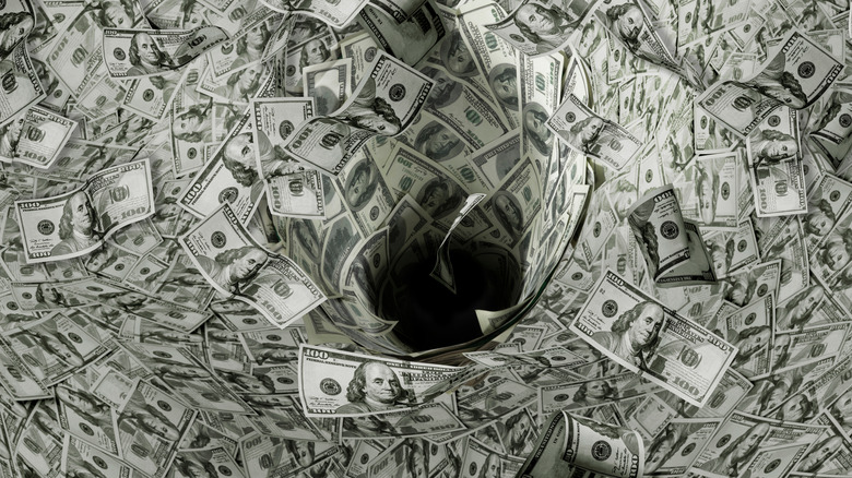 $100 bills swirling into black hole