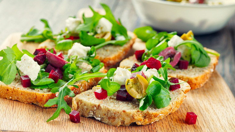 watercress and other vegetables on slices of toast