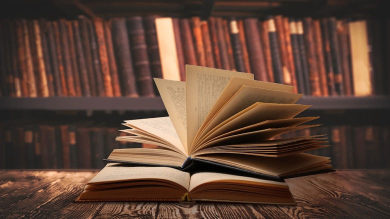 vintage books open on library table
