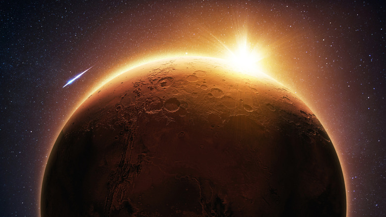 A render of Mars seen from space with light cresting over the surface