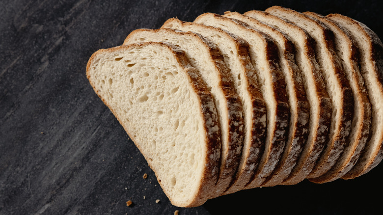 Sliced bread sits on a dark surface