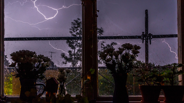 Lightning storm seen through a window from inside a building
