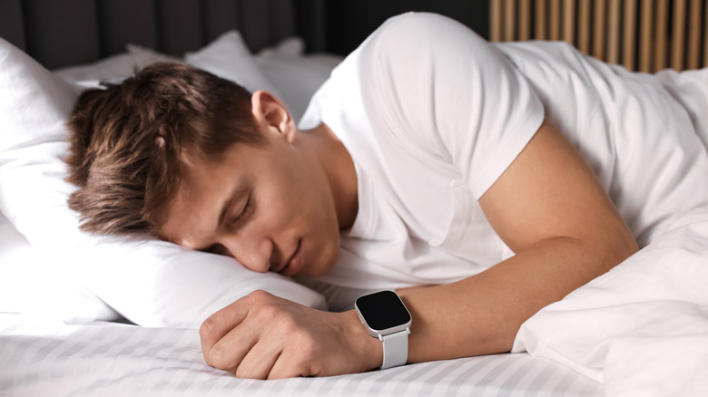 Young man sleeping soundly in bed