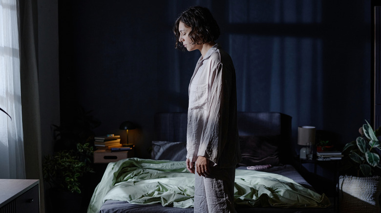 Woman sleepwalking in her bedroom