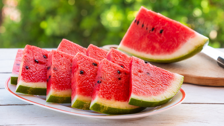 Slices of fresh watermelon served on a white platter