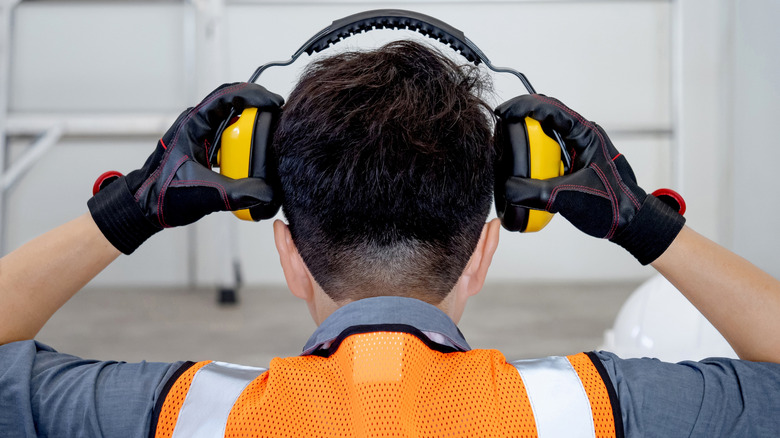 Person putting on ear protectors