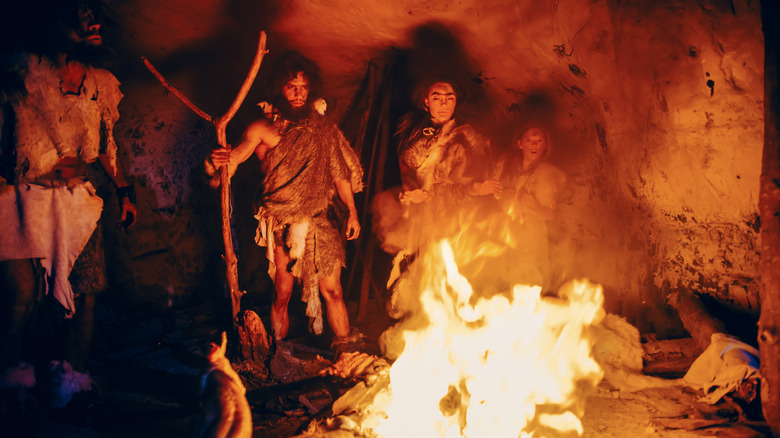 Prehistoric hunter gatherers around a bonfire