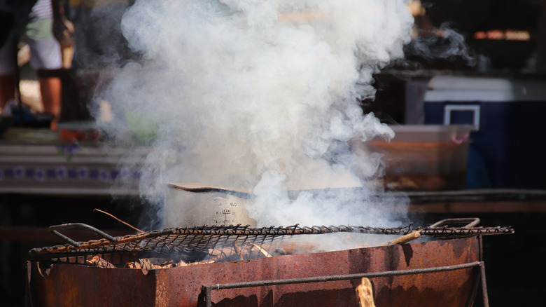 Smoke rises from a cooking fire