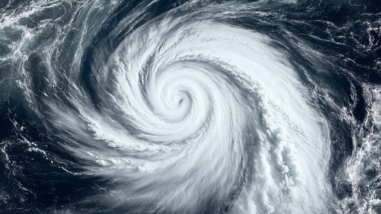 Satellite image of hurricane over the ocean, two armed white swirl amid dark blue water