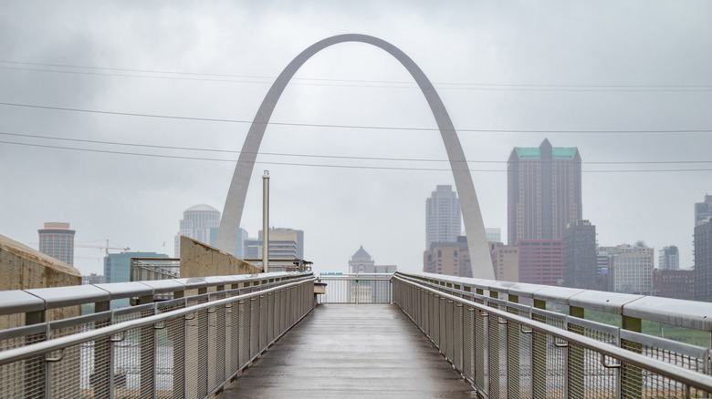 The gateway arch in St. Louis partially covered by fog.