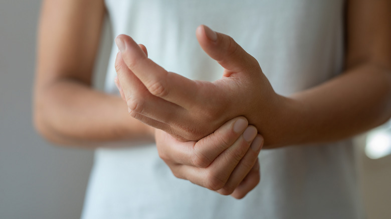 Woman massaging hands