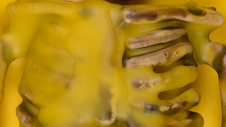 A skeleton covered in yellow wax.