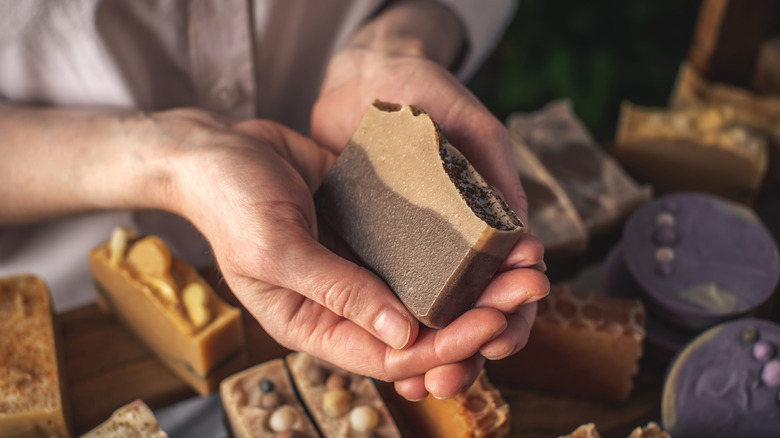 A person holding a bar of soap.